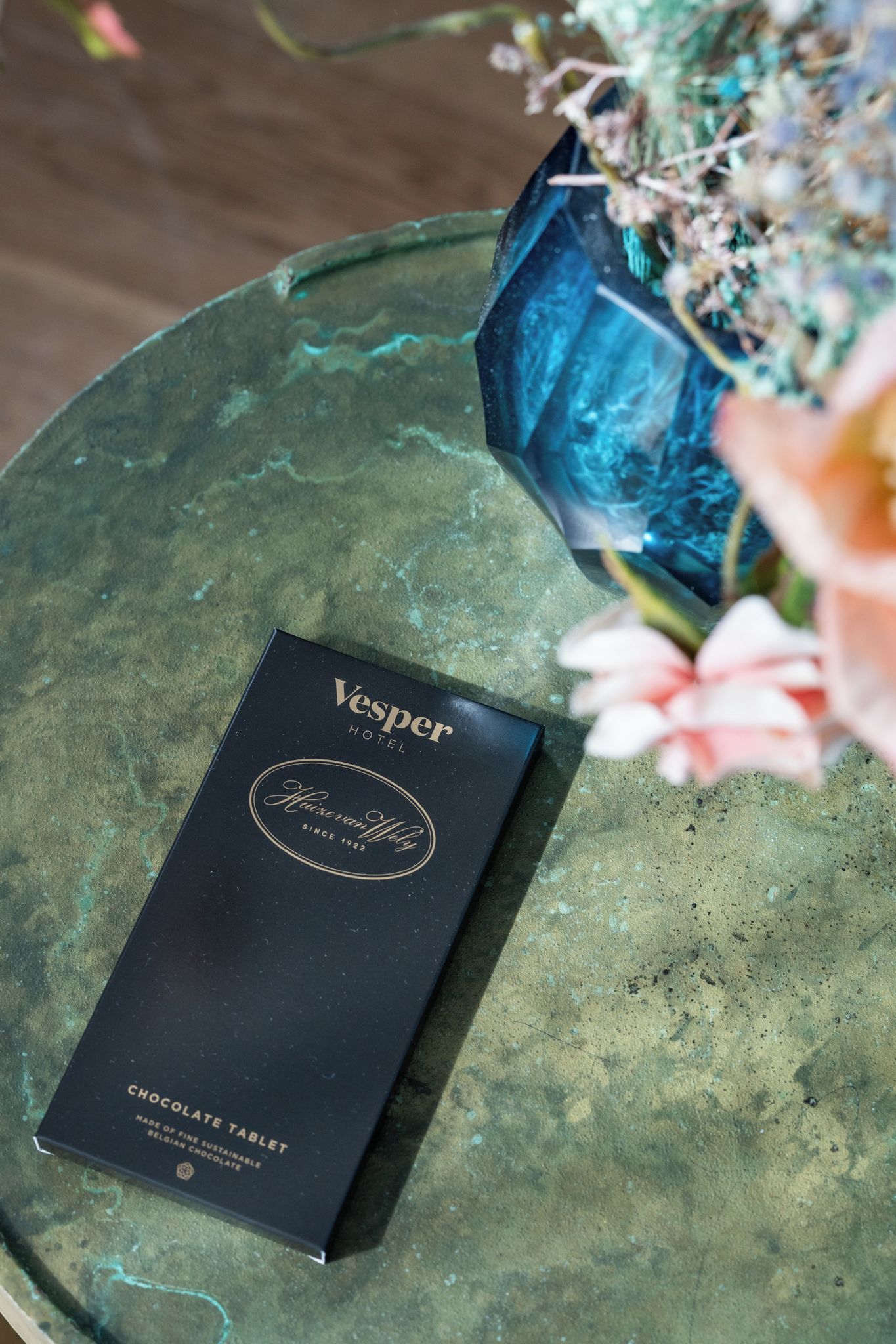 A black box labeled 'Vesper Hotel' and 'Chocolate Table' on a green surface.