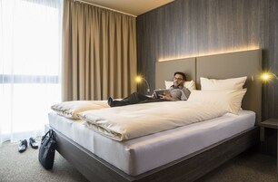 Premium bedding, desk, laptop workspace, blackout drapes