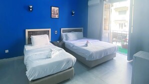 A hotel room with two beds, a large window with a view, and a balcony. - The Australian Hostel (Cairo)