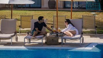 Indoor pool, outdoor pool, open 8:00 AM to 8:00 PM, pool loungers