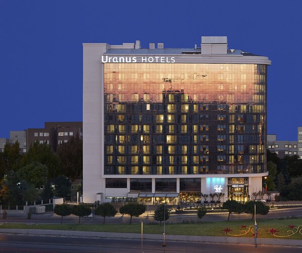 A modern hotel building with the name "Uranus Hotels" prominently displayed.