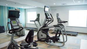 A fitness center with treadmills, elliptical machines, and a stationary bike.