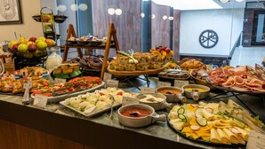 A buffet with various food items including fruits, cheeses, and meats. - Constantine the Great (Belgrade)