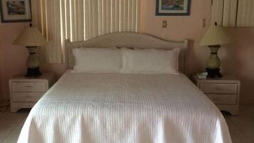 A neatly made bed in a room with a simple, clean design.