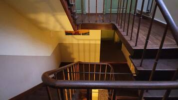 A staircase with metal railings and wooden steps.