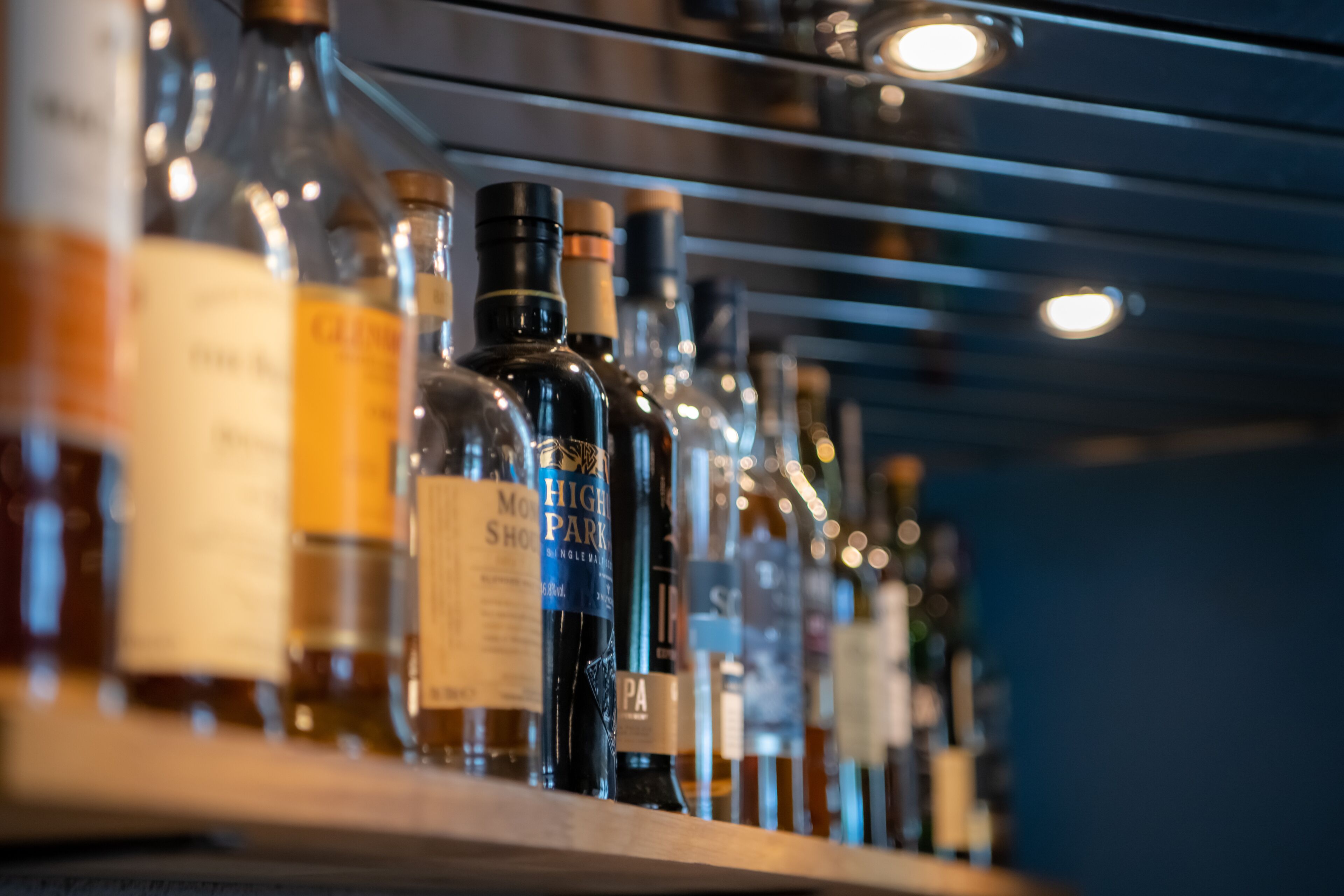 A row of liquor bottles on a shelf.