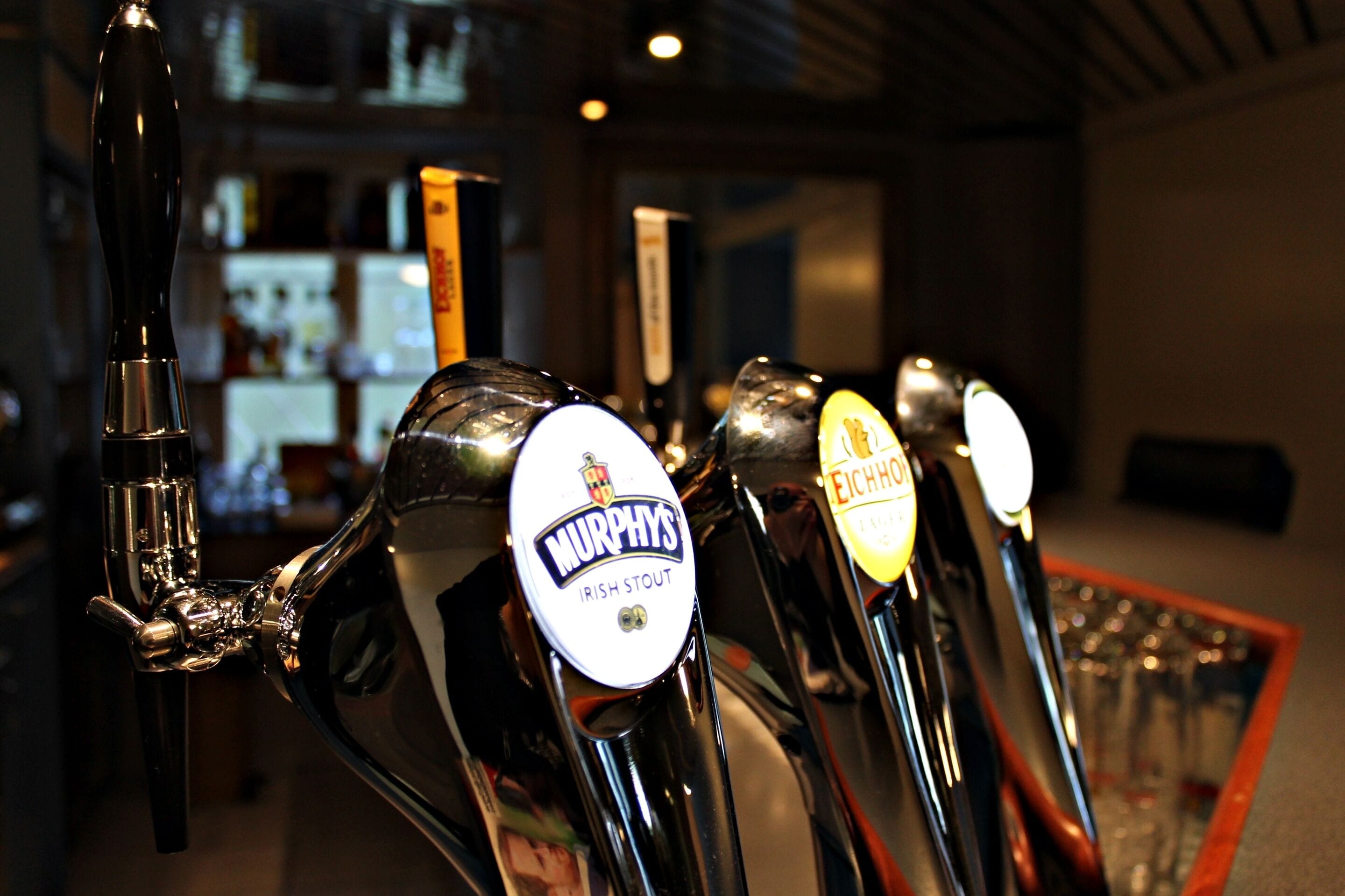 A row of beer taps with labels including "Murphy's Irish Stout" and "Eichhorn."