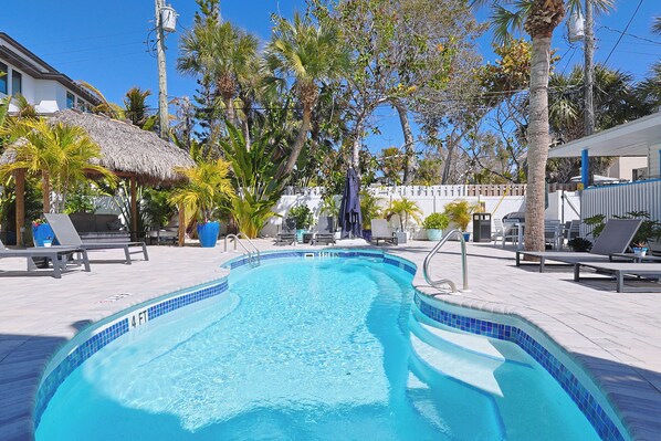 Outdoor pool, a heated pool, open 8:00 AM to 8:00 PM, pool umbrellas