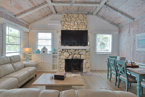 The Cottage, 3 Bedroom 2 Bath (2 Kings, 1 Queen, 2 Twins) | Living area | 65-inch Smart TV with cable channels, TV, DVD player