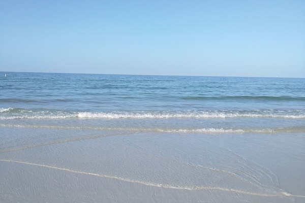 Beach nearby, white sand, beach umbrellas, beach towels