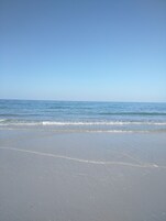 Beach nearby, white sand, beach umbrellas, beach towels