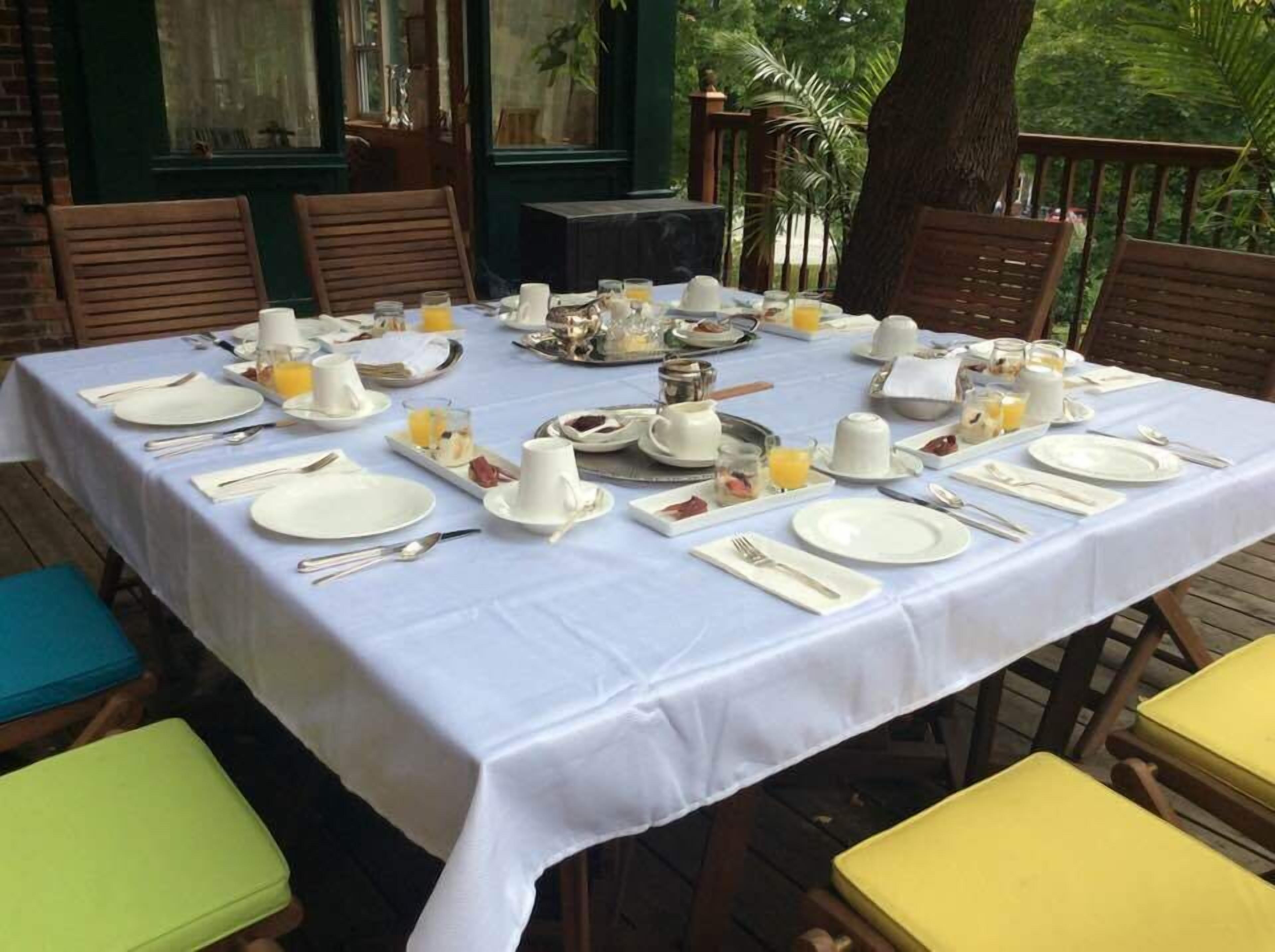 A table set for breakfast with plates, cups, and cutlery.