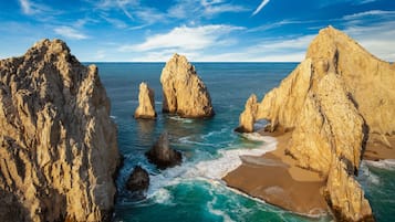 Di pantai, kursi berjemur, payung pantai, dan handuk pantai