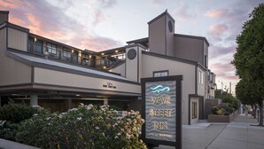 A hotel with a modern design, featuring a prominent sign for the Wave Street Inn. - Wave Street Inn (Monterey)