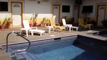 Outdoor pool, open 9:00 AM to 8:00 PM, pool umbrellas, pool loungers