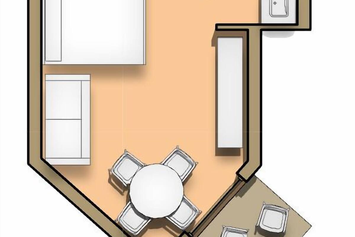Un aménagement de chambre d’hôtel comprenant un lit, un bureau, une chaise, une petite table et un canapé.