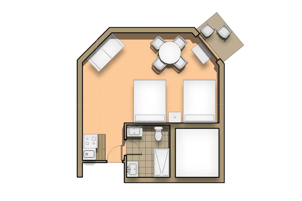 Un appartement de deux chambres comprenant une cuisine, un coin repas et un petit balcon.
