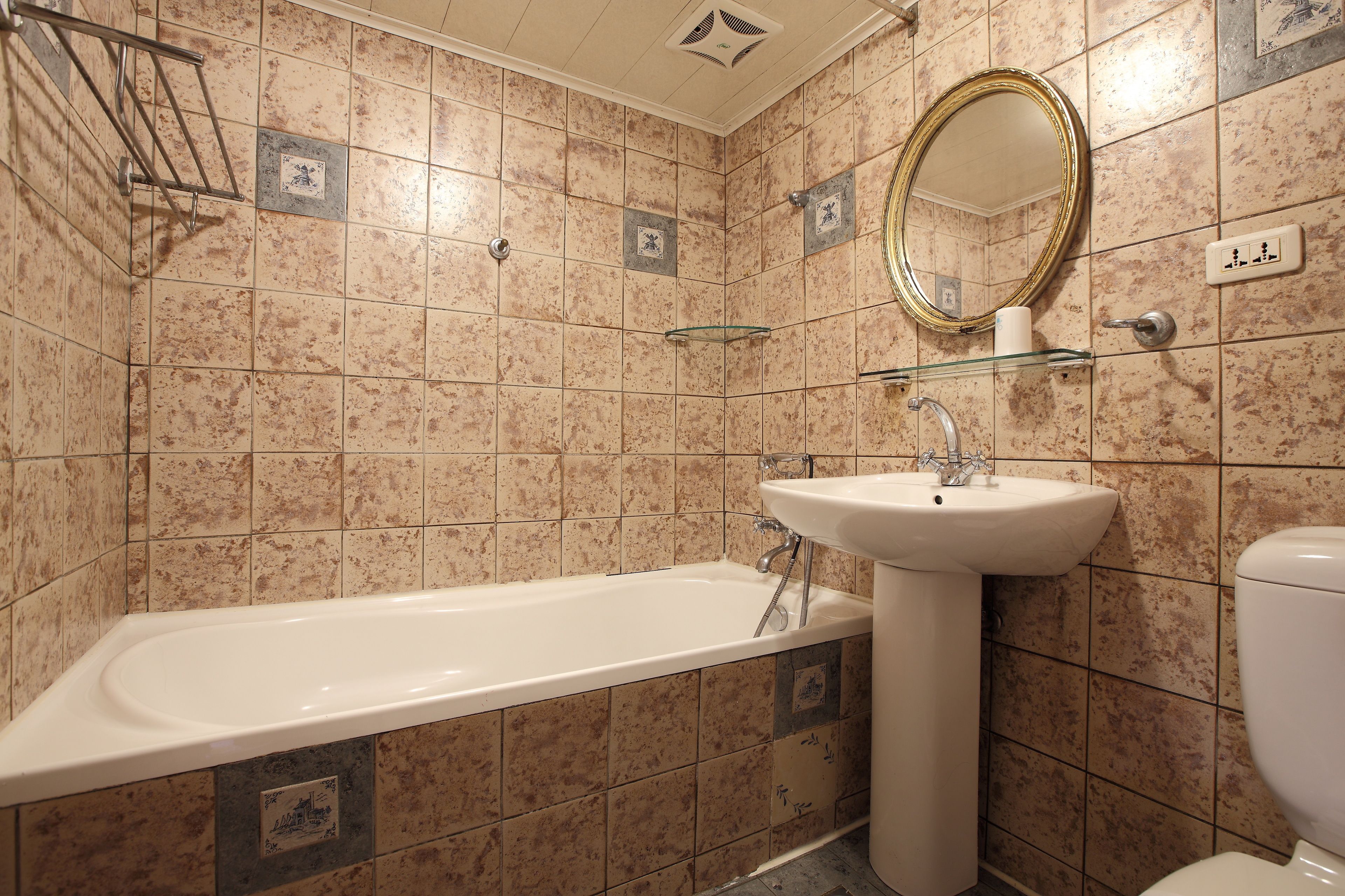 A bathroom with a bathtub, sink, and toilet.