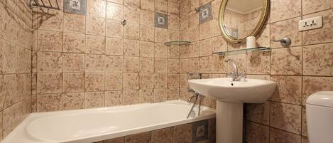 A bathroom with a bathtub, sink, and toilet.