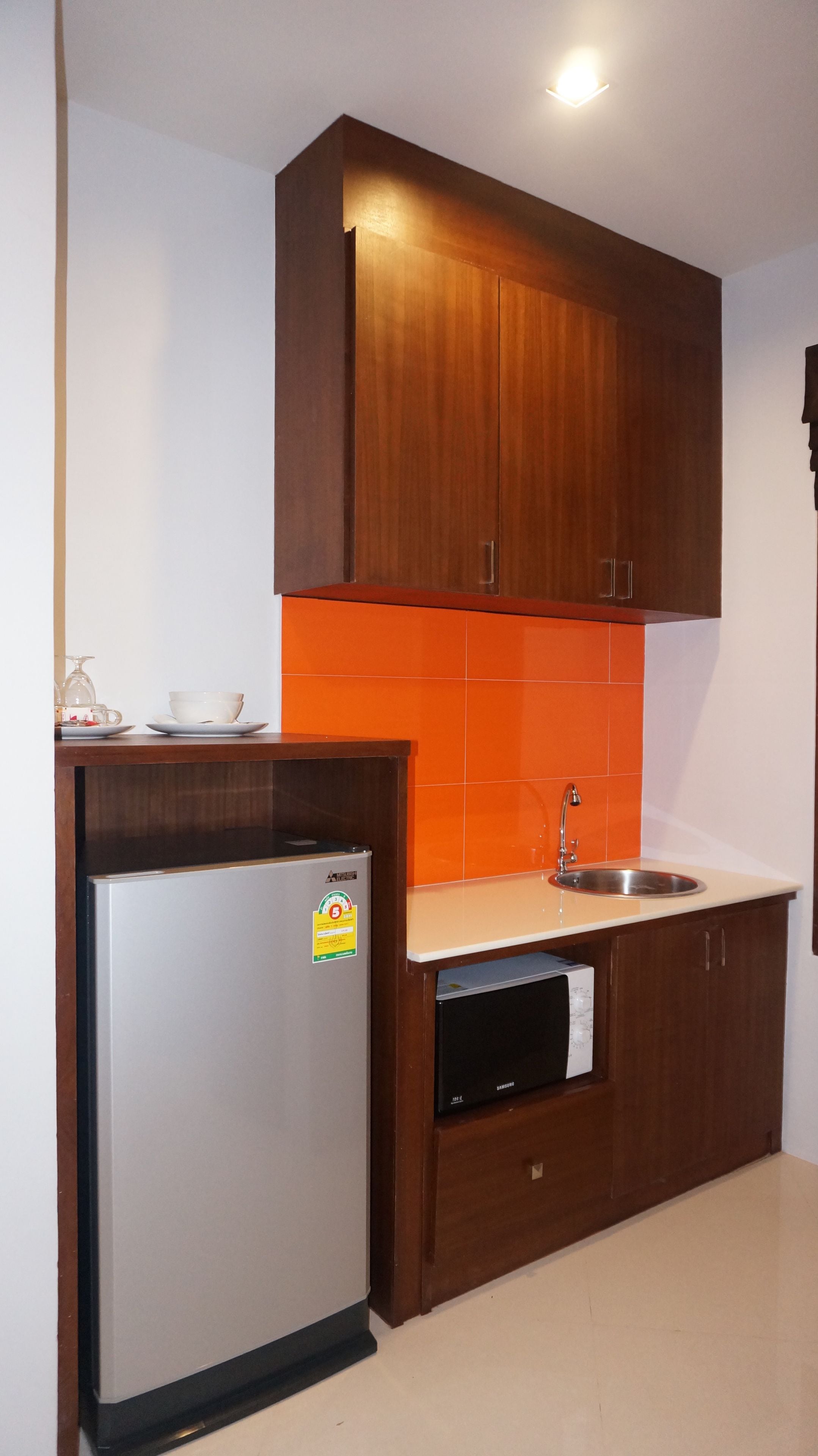 fridge, coffee/tea maker, electric kettle, cookware/dishes/utensils