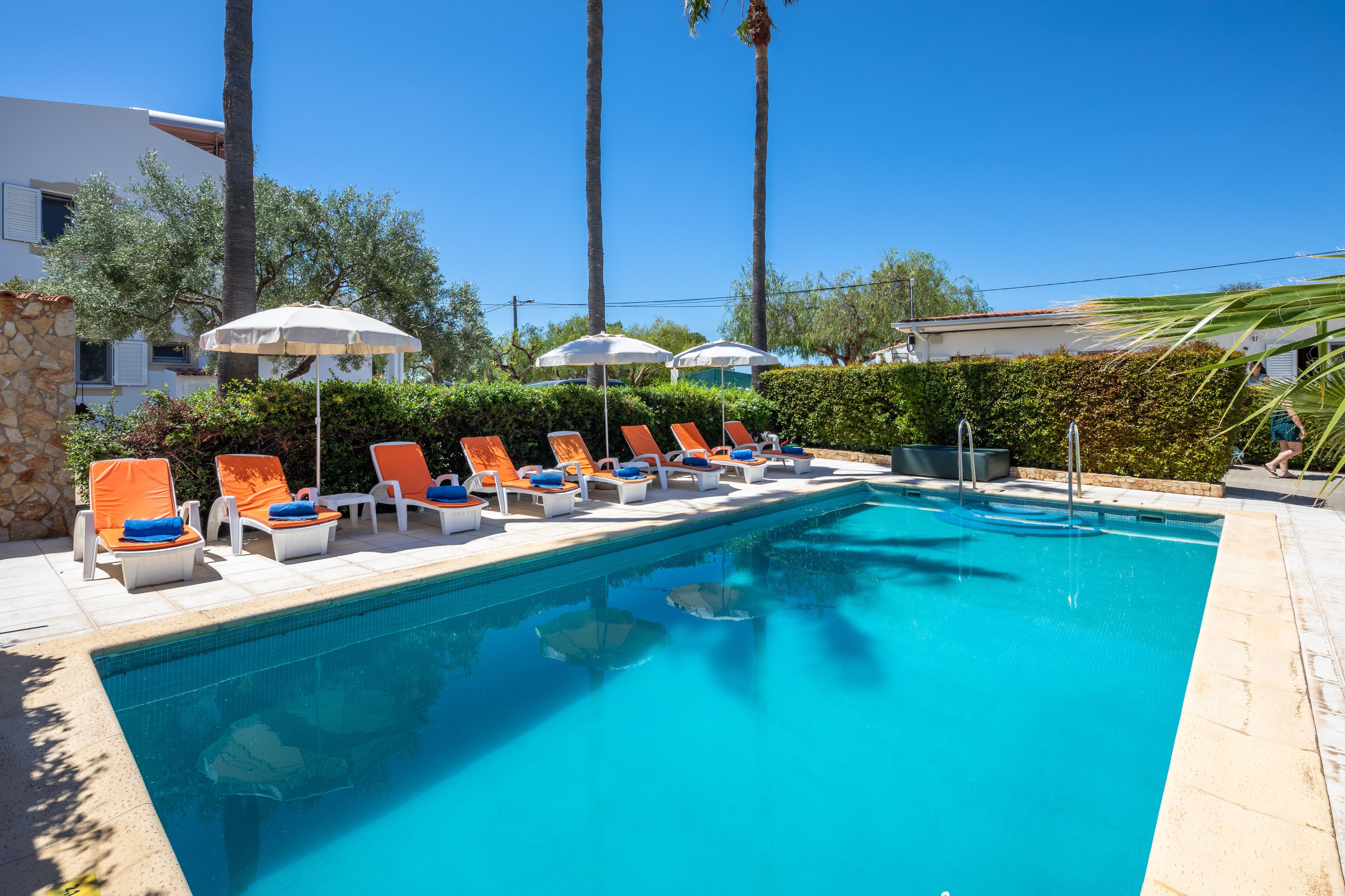 2 outdoor pools, open 8 AM to 10 PM, pool umbrellas, pool loungers
