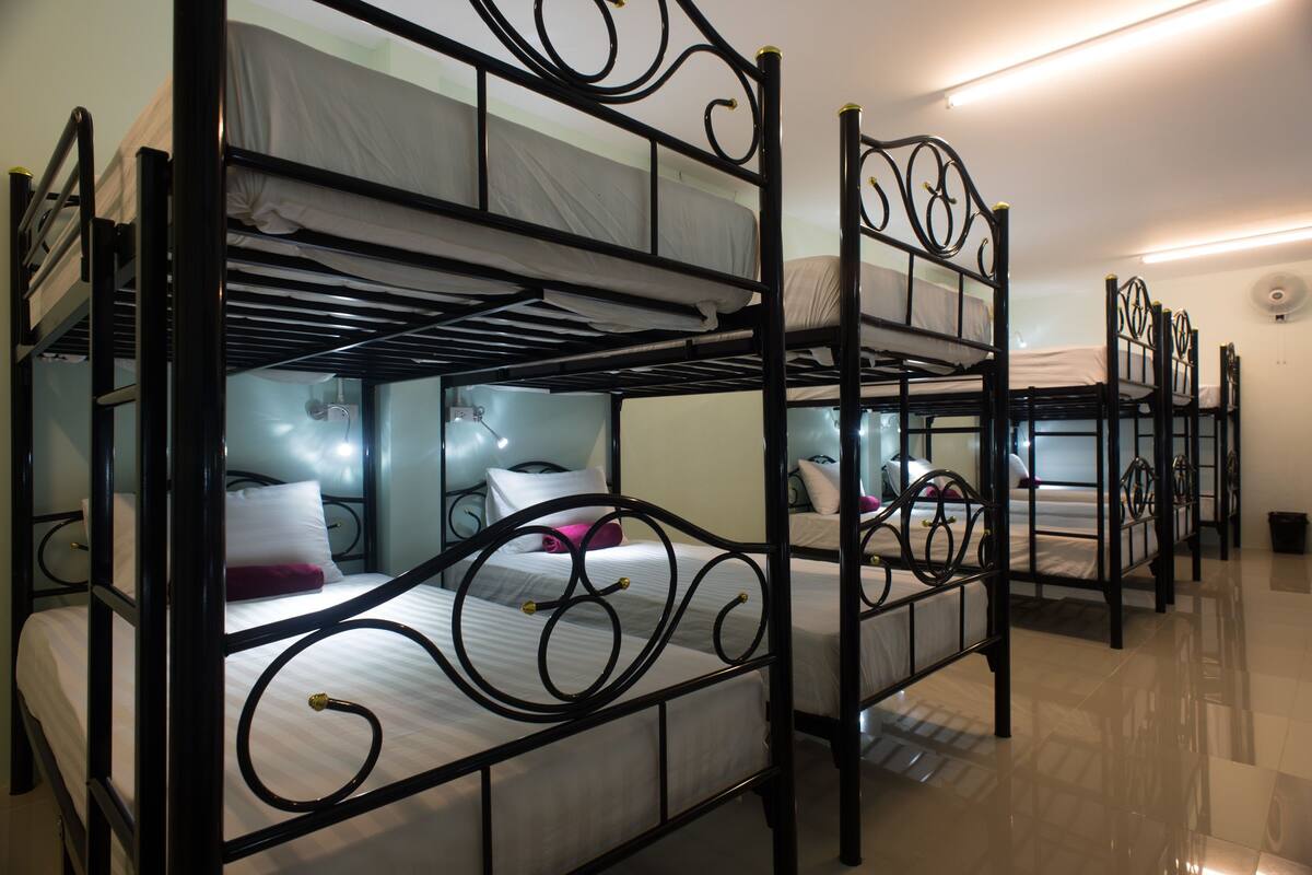A room with bunk beds arranged in rows.