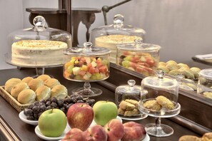 A buffet with various food items including cakes, fruits, and pastries. - Casa Ellul - Small Luxury Hotels of the World (Valletta)