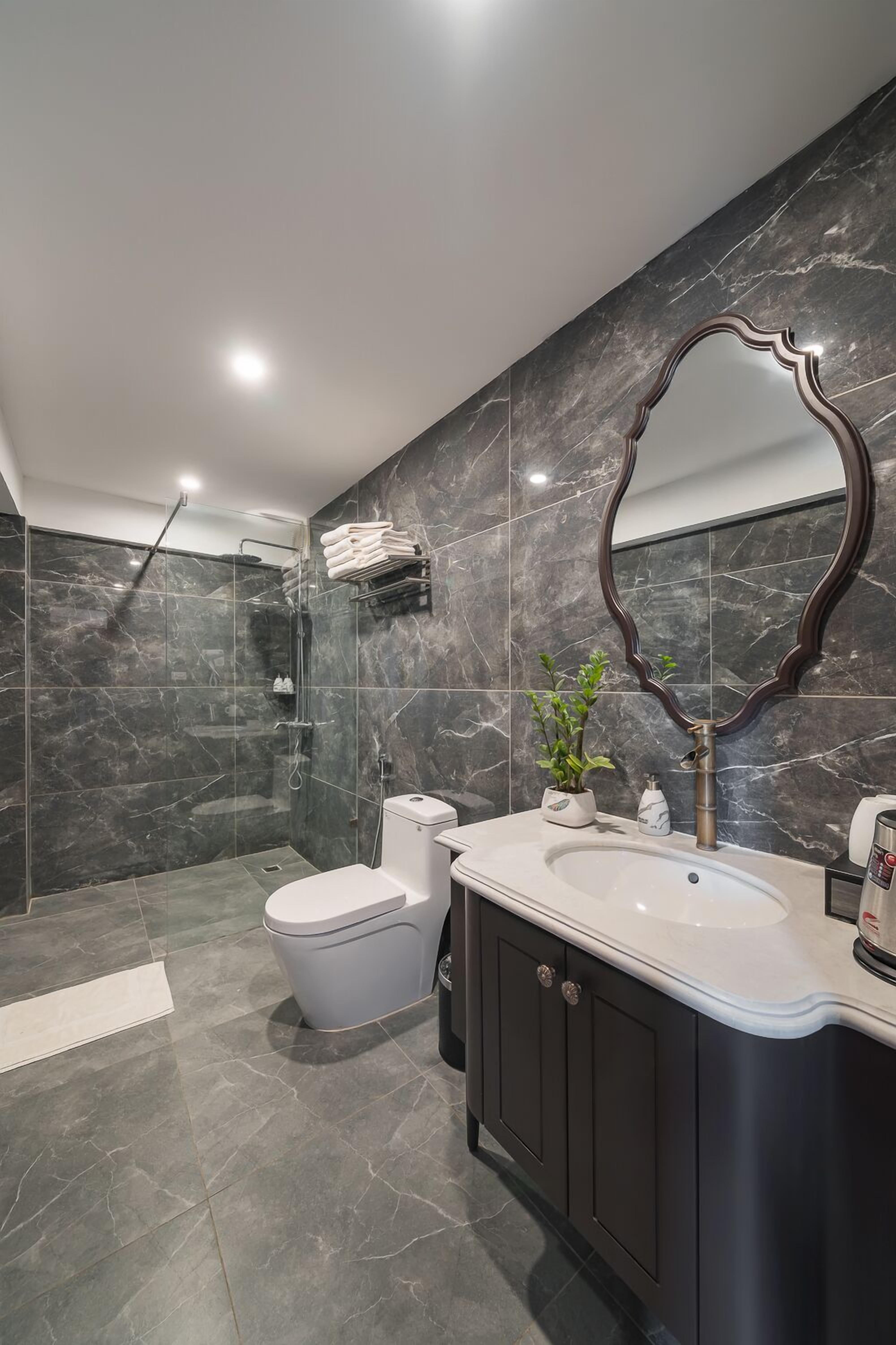 family suite, 1 bedroom, kitchen, city view (1 king bed and 2 single beds) | bathroom | spring water bathtub, rainfall showerhead, designer toiletries