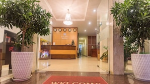 A hotel reception area with a 'Welcome' mat, reception desk, and a chandelier. - Galaxy Hotel Phu Quoc (Phu Quoc)