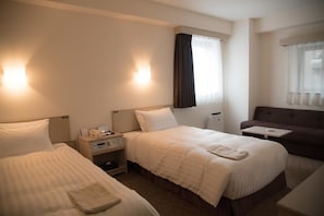A hotel room with two beds, a small table, a sofa, and a window with curtains. - Best Western Osaka Tsukamoto (Osaka)