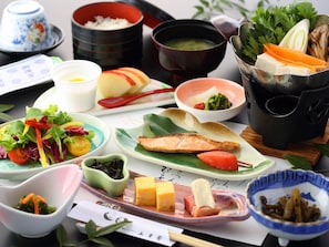A variety of dishes including salmon, vegetables, and rice, suggesting a meal setting.