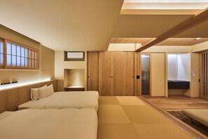 A hotel room with a large bed, a wooden wardrobe, a desk, and a bathroom. - Yu no Yado Shoei (Kyoto)