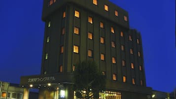 A multi-story hotel building with illuminated signage at the top.