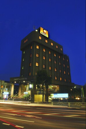 A multi-story hotel building with illuminated signage at the top. - Kumegawa Wing Hotel (Higashimurayama)