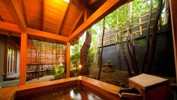 Ein traditionelles japanisches Onsen mit Holzbalken und einer Holzterrasse.