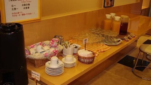 A buffet setup with various food items and utensils. - Idaimae Green Hotel (Saga)