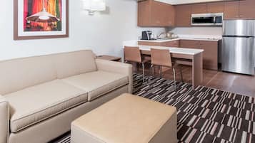 Cozy living space with a kitchenette, sofa, and dining area.