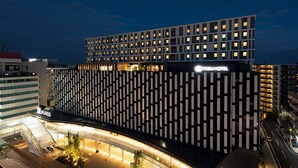 A modern hotel with a prominent sign, a covered entrance, and a well-lit facade. - Kawagoe Tobu Hotel (Kawagoe)