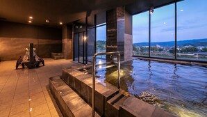 A modern indoor pool area with a view of the landscape through large windows. - Hitoyoshi Onsen Nabeya (Hitoyoshi)