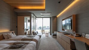 A modern hotel room with a large bed, a desk, and a TV. - Hitoyoshi Onsen Nabeya (Hitoyoshi)