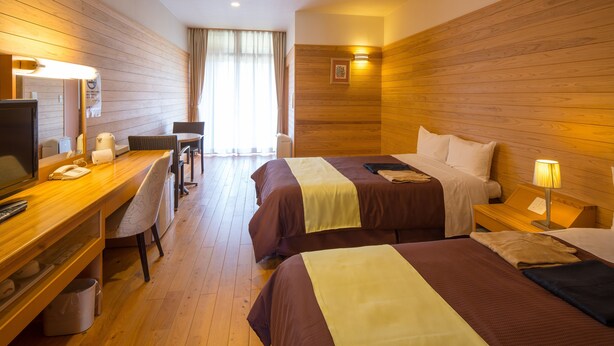 A hotel room with two beds, a desk with a telephone, a chair, and a television. - Fontana No Oka Kamo (Aira)
