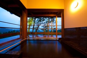 A room with a large window, wooden floor, and a wall-mounted light fixture. - Kusayane no Yado Ryunohige (Yufu)