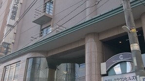 Ein mehrstöckiges Gebäude mit Balkonen und einem Schild, das ein Hotel kennzeichnet.