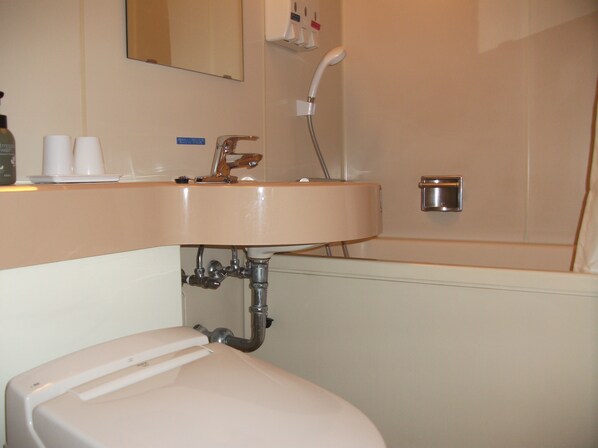 A bathroom with a sink, toilet, and shower. - Hotel Crown Hills Sagamihara (Sagamihara)