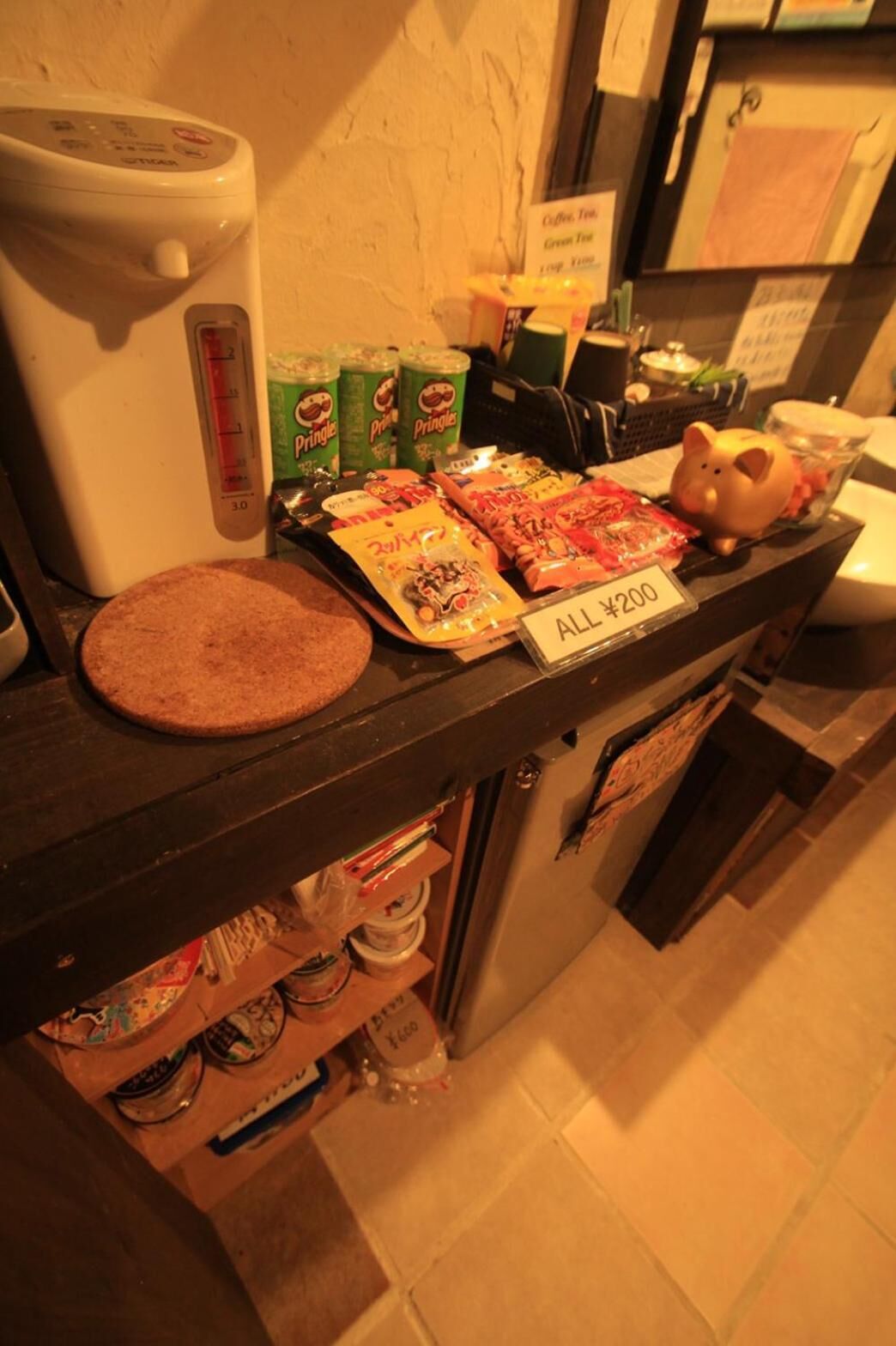 A buffet counter with a coffee maker, Pringles, and snacks.
