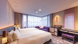 A modern hotel room with a large bed, a desk, a chair, and a sofa. - Miyako City Kintetsu Kyoto Station (Kyoto)