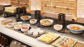 A buffet with various dishes and drinks, including seafood, salads, and desserts, arranged on a counter with a decorative bamboo backdrop. - Miyako City Kintetsu Kyoto Station (Kyoto)