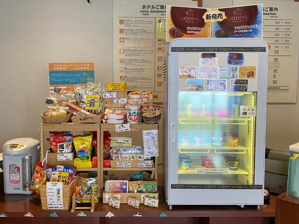 A vending machine stocked with various snacks and a display of packaged goods.