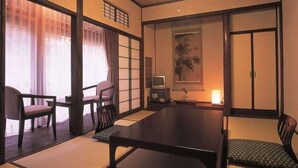 A traditional Japanese room with tatami flooring, a low table, and sliding doors. - Yume-hotaru (Amakusa)