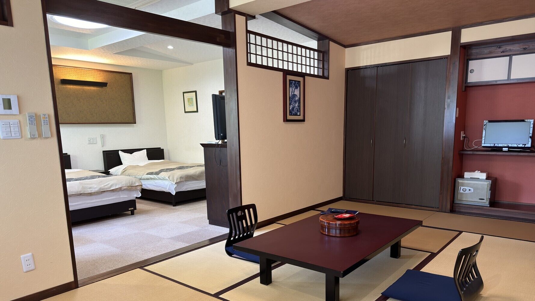 Una habitación de hotel con cama, escritorio, silla, televisión y armario.